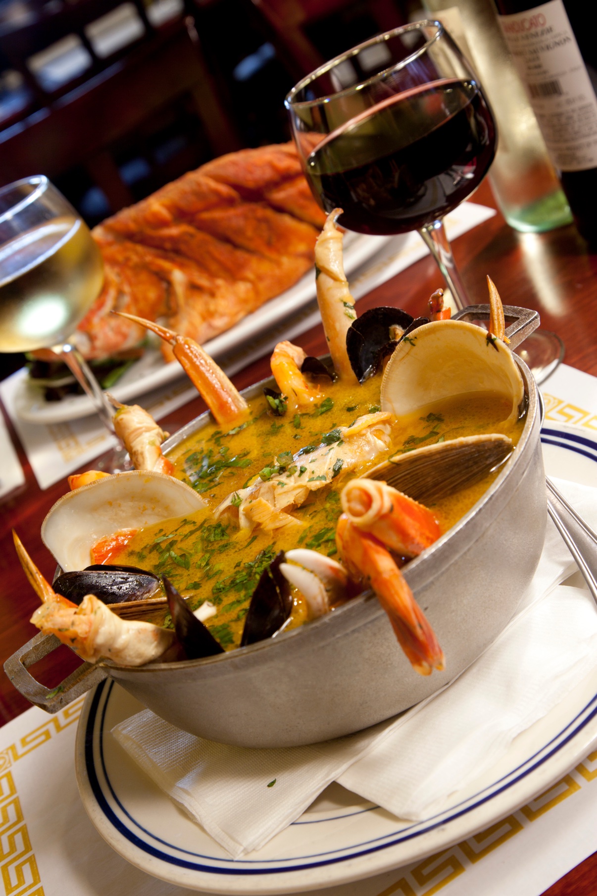 Seafood stew with prawns, clams and mussels served with wine