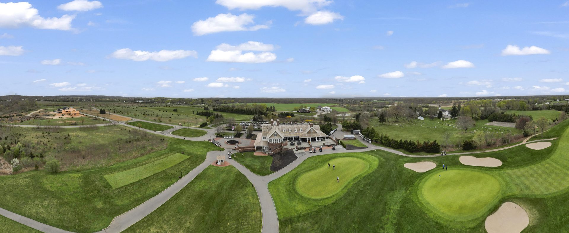 Wide aerial drone view of a golf course community