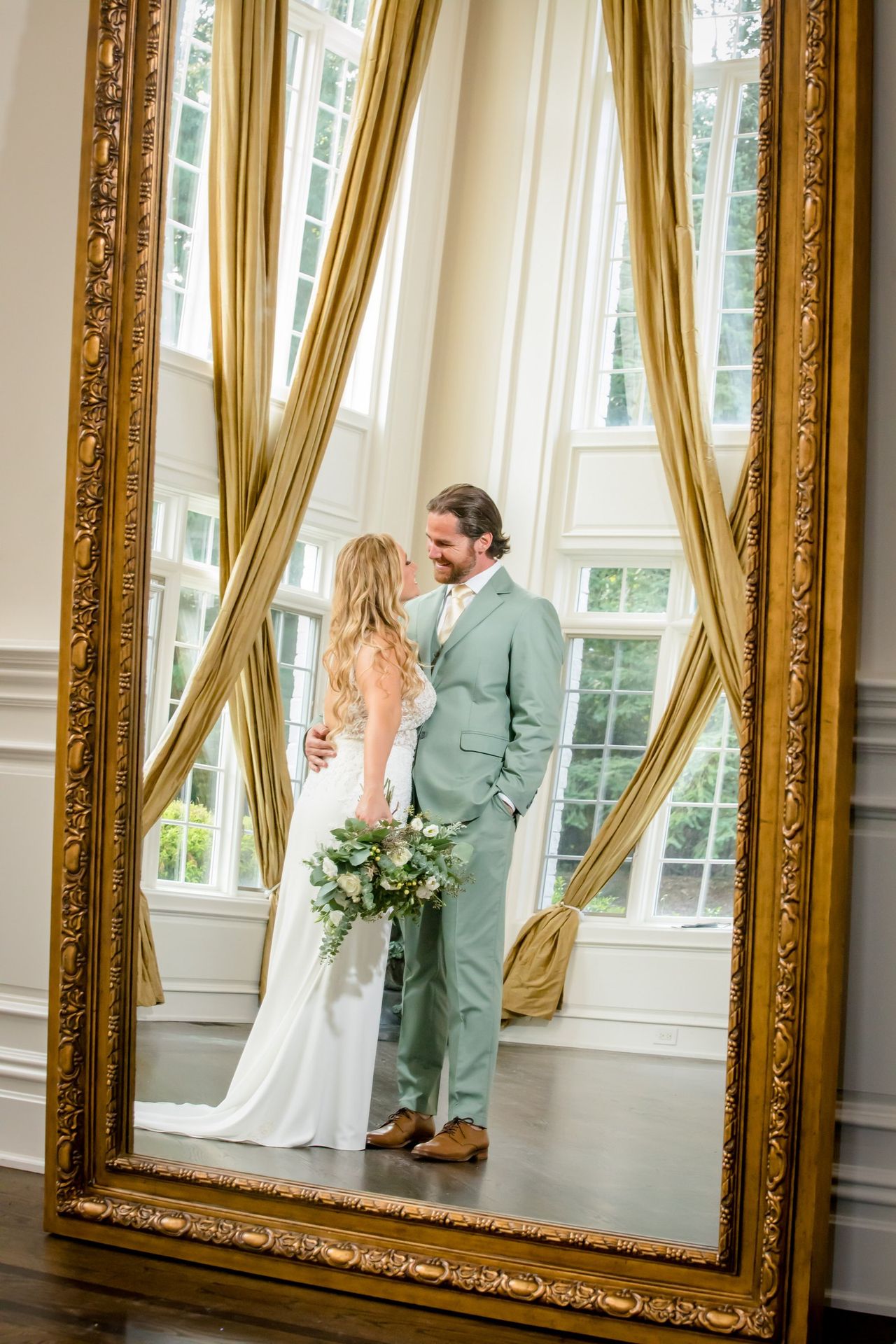 Bride reflected in a full-length mirror before her ceremony