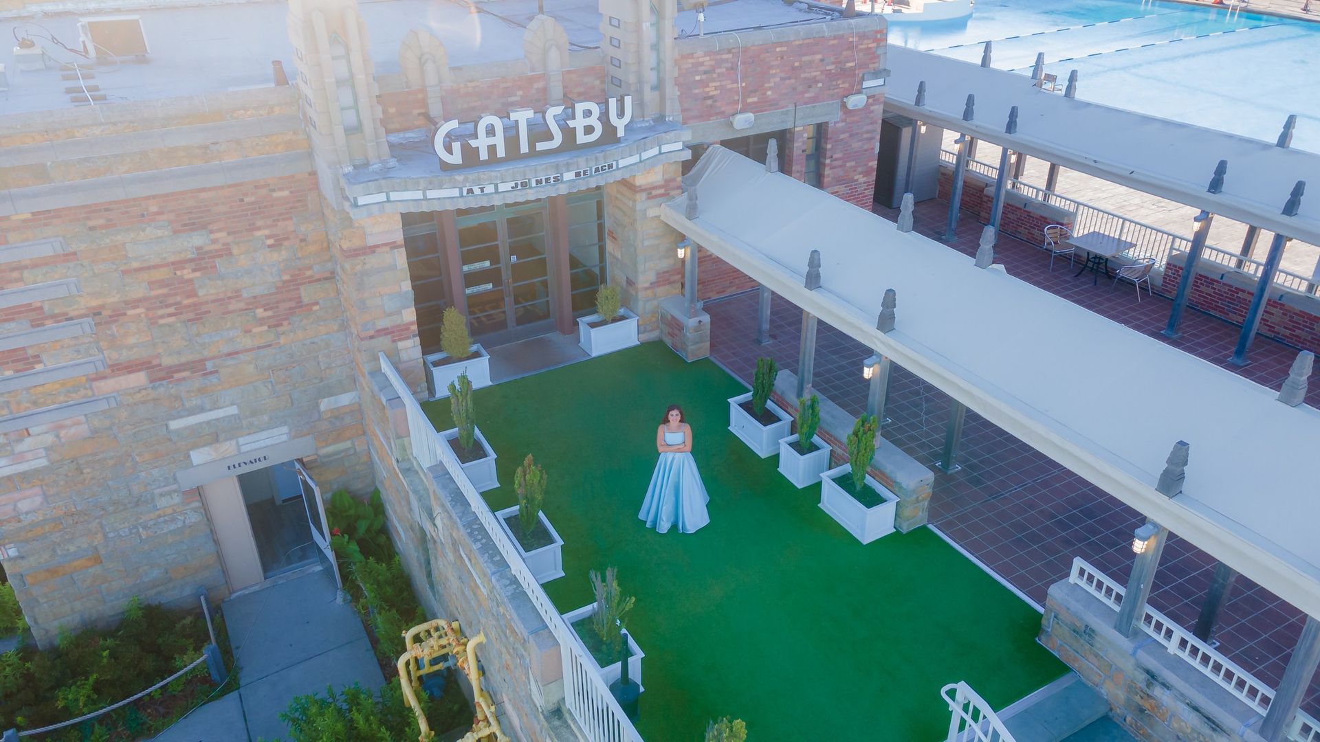 Aerial portrait of a Sweet 16 celebrant in a blue gown at Gatsby on the Ocean