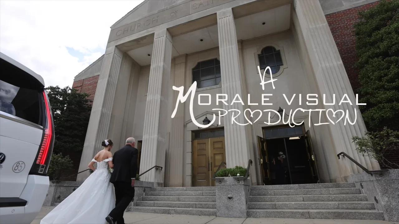 Newlyweds on the steps of a grand courthouse-style building with the Morale Visual Production signature
