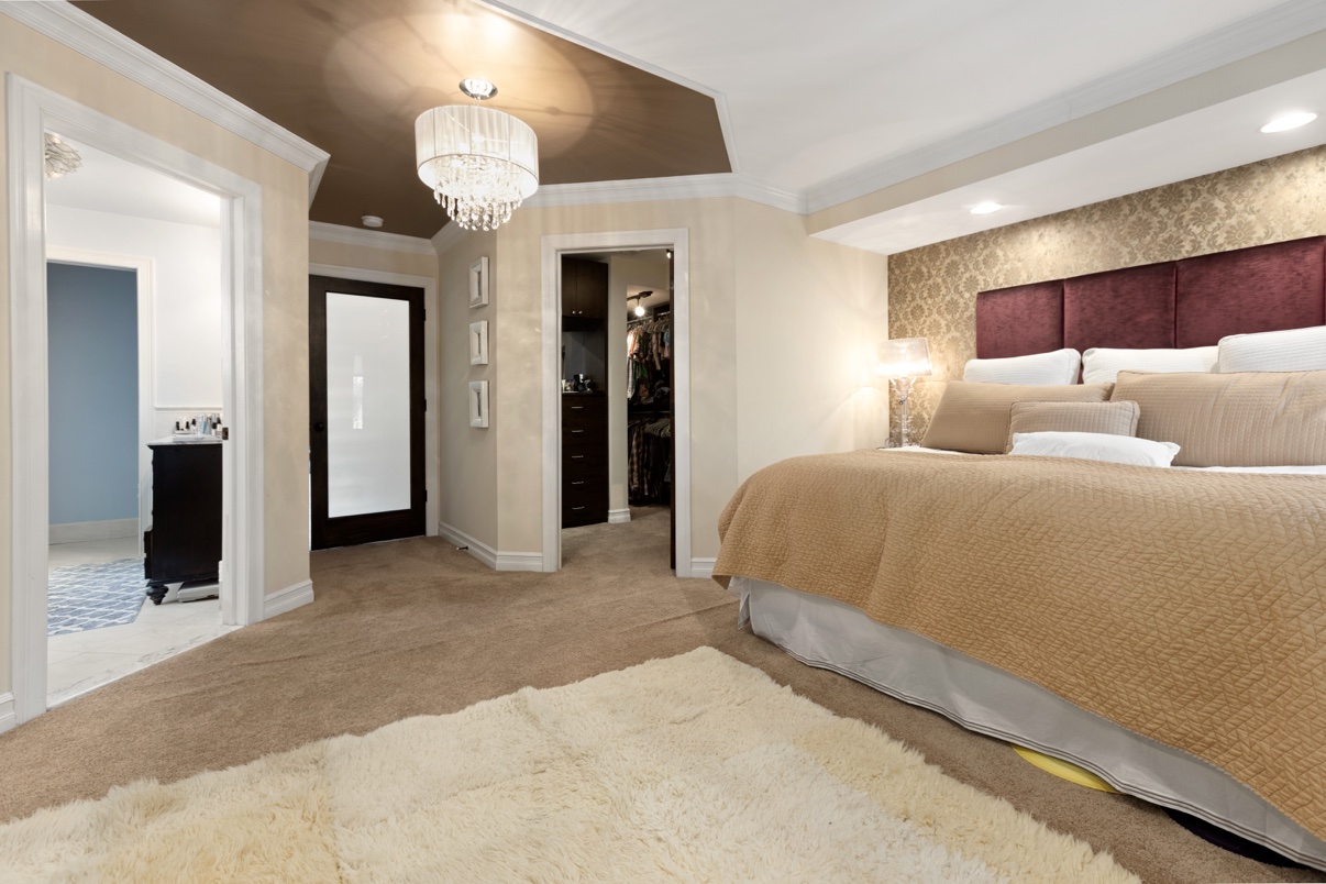 Luxury bedroom with a chandelier, walk-in closet and ensuite bath