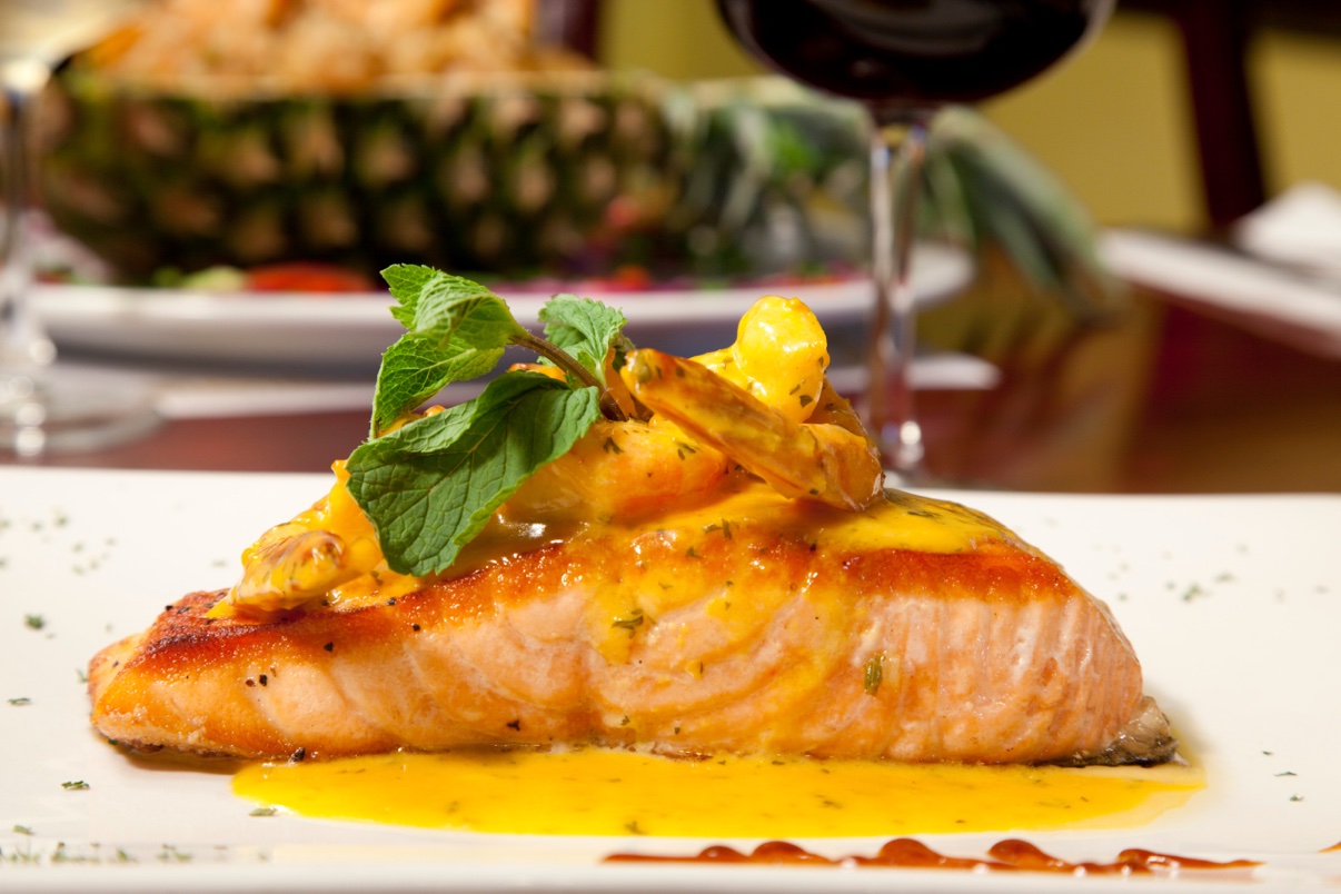 Pan-seared salmon topped with shrimp and fresh mint