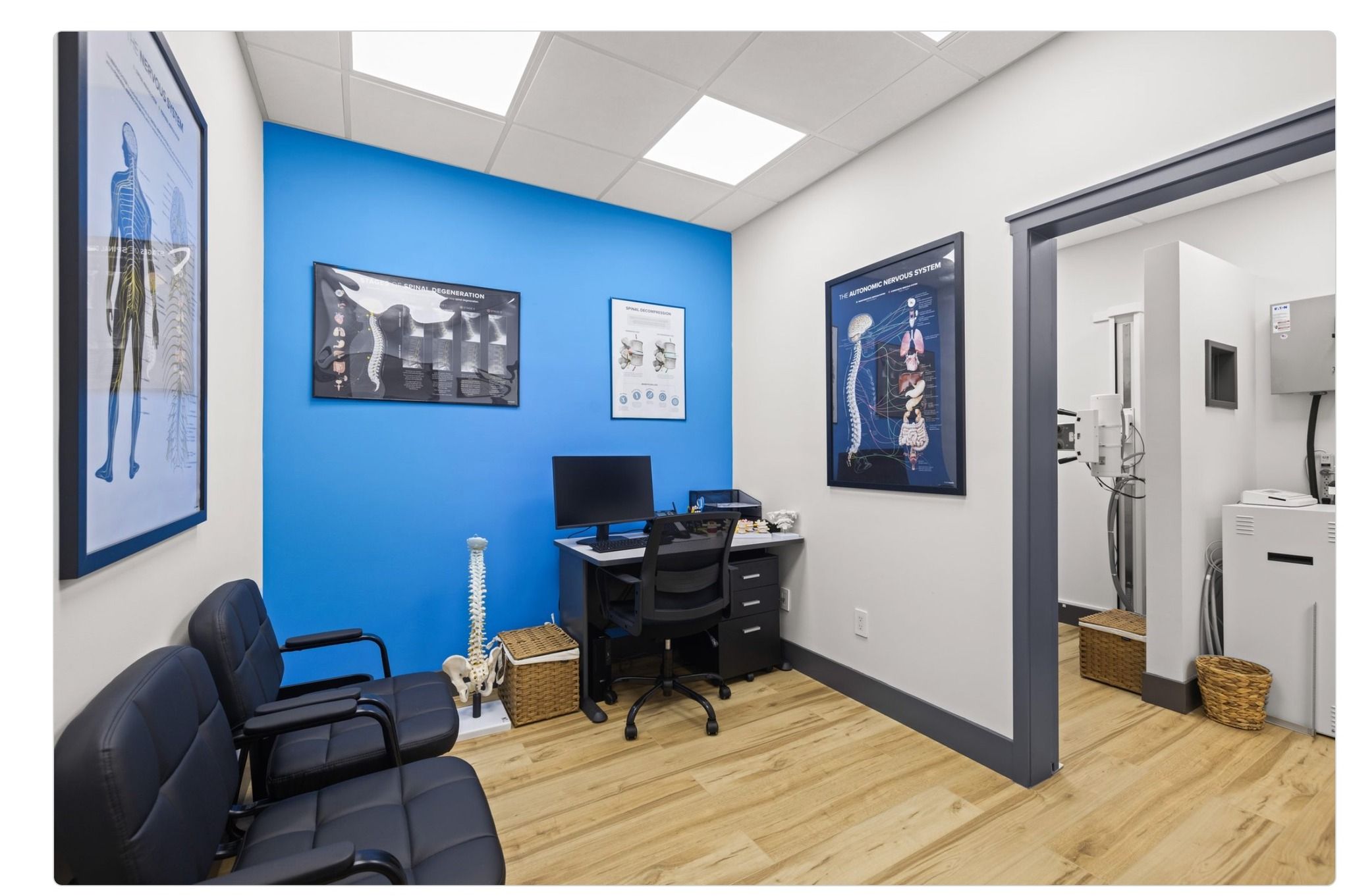 Chiropractic exam room with educational posters