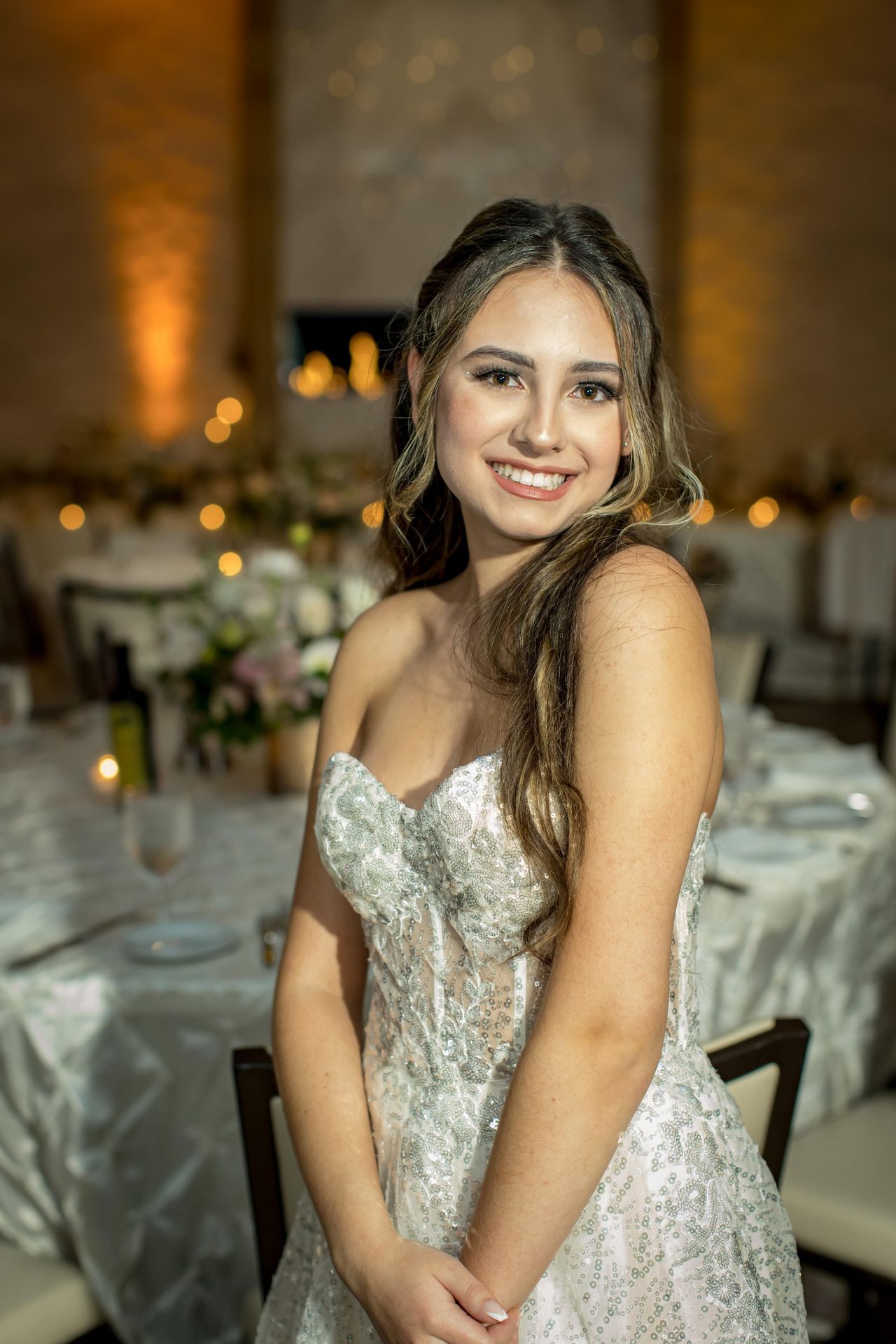 Sweet 16 celebrant in a sparkling silver gown at her reception