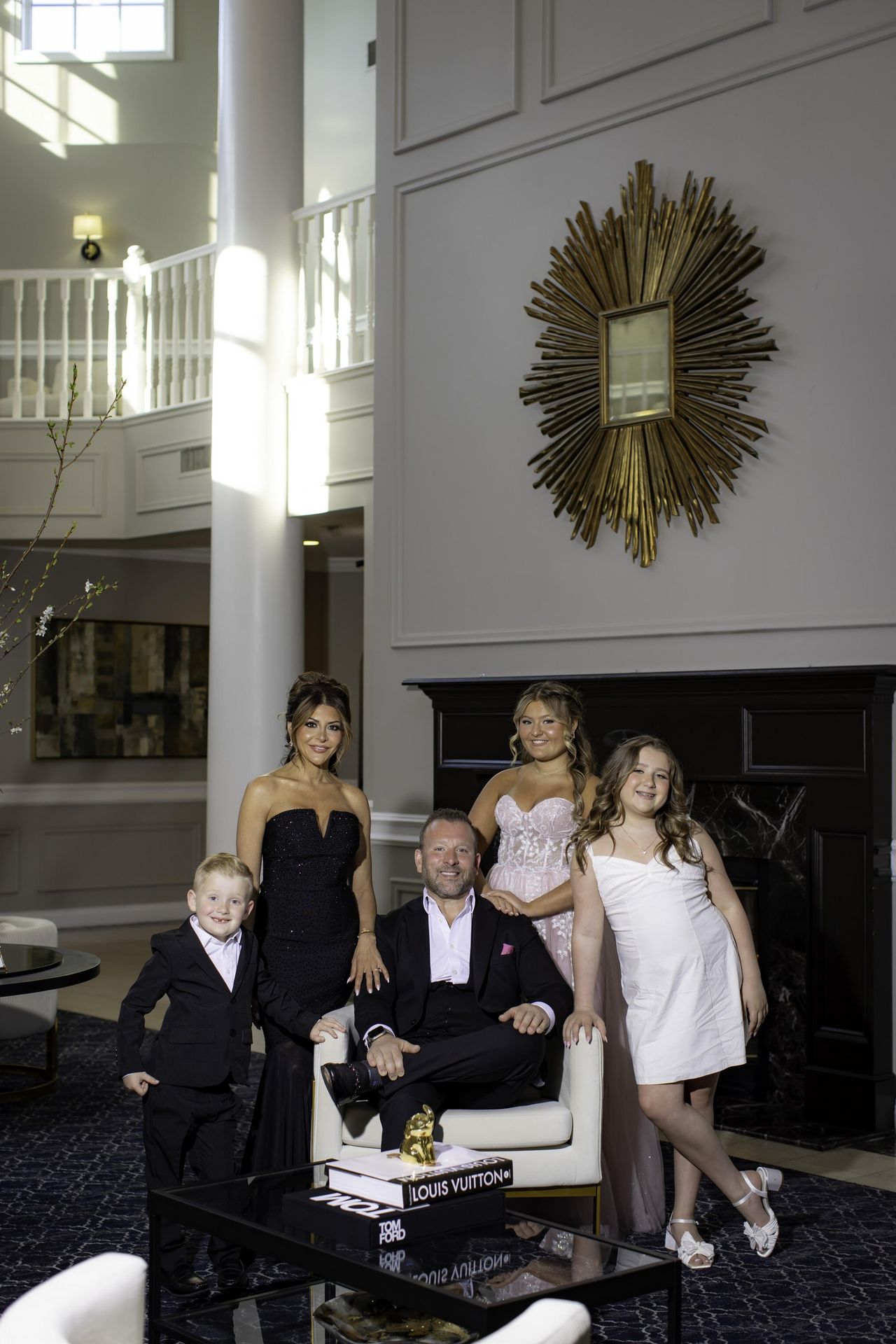 Sweet 16 celebrant posing with her family in an elegant lounge