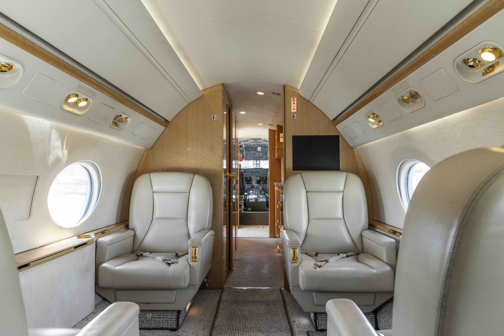 Private jet cabin seating by the windows