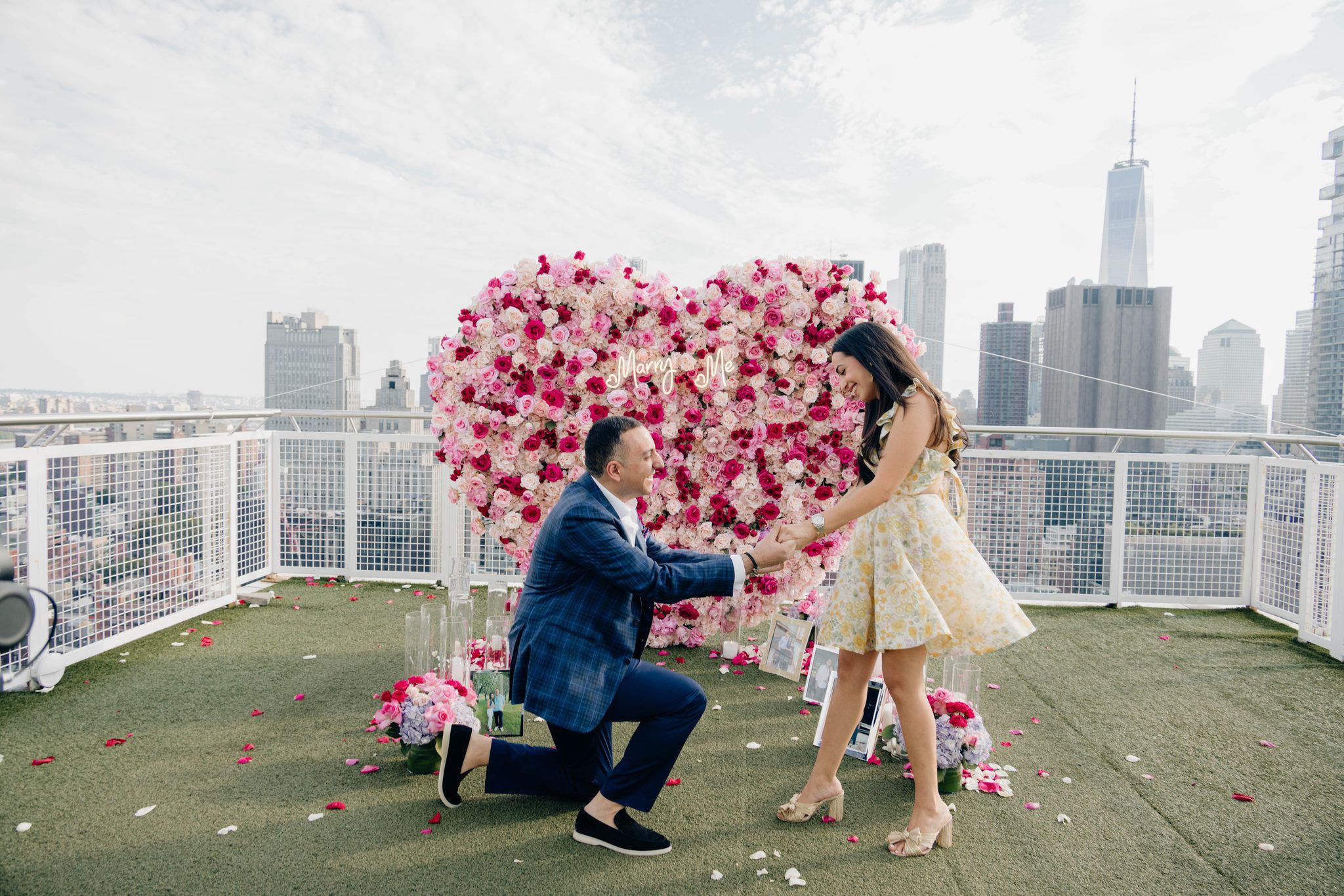 Rooftop proposal with a pink flower heart